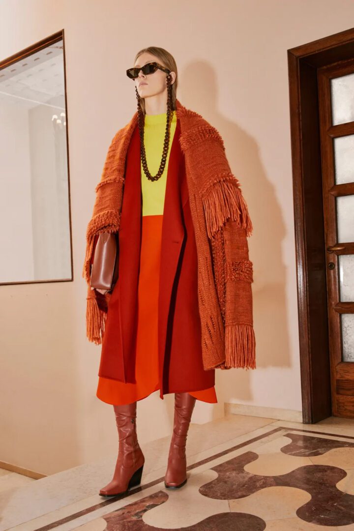 Stella McCartney Pre Fall 2022 Collection I Fringed Rust Knit Overcoat, fitted mock neck knit tank and a-lice midi skirt #fashionstyle #ootdstyle