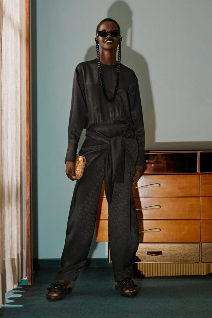Stella McCartney Pre-Fall 2022 Collection I Black All-in-One jumpsuit and with sparkling gold handbag and cushioned faux leather slide sandals #fashionstyle #ootdstyle
