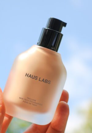 A hand showcasing Haus Labs skin tech foundation.