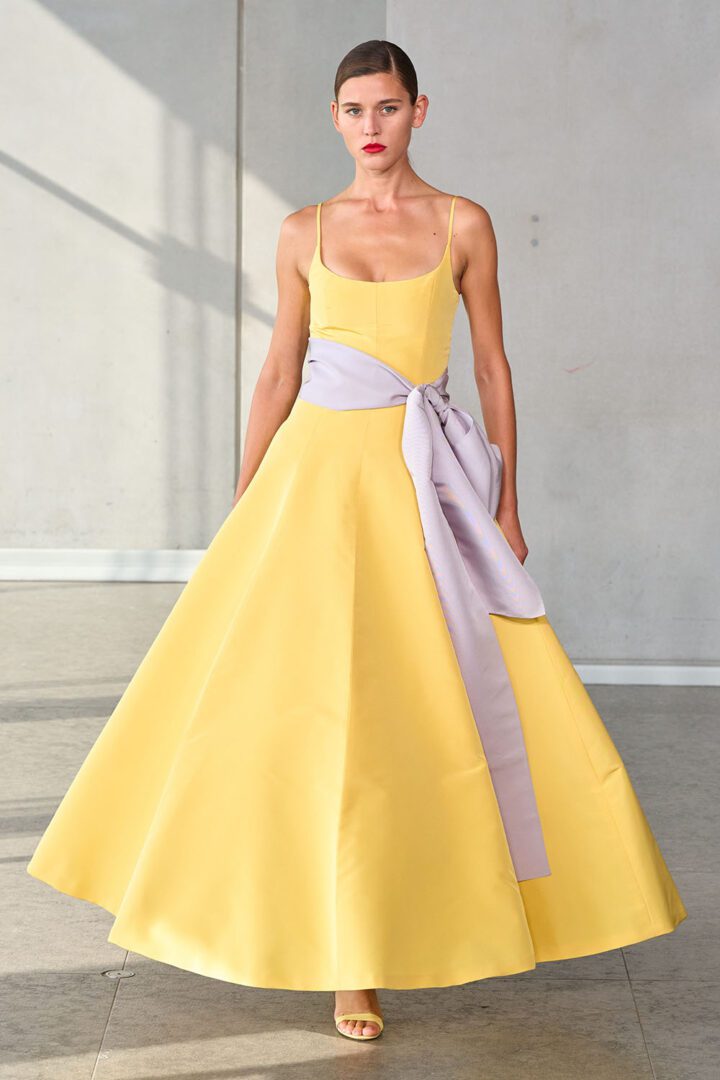 Best NYFW Spring 2024 Looks I Carolina Herrera yellow A-line midi dress with lavendar bow